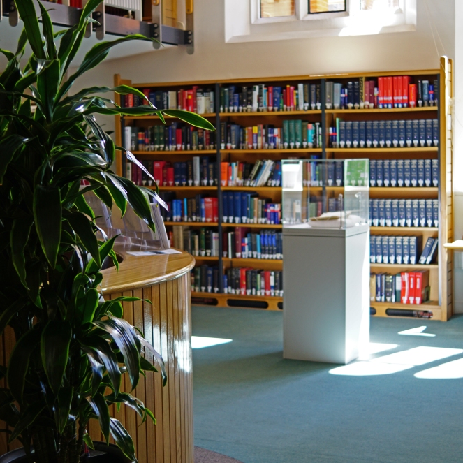 Photograph of bookshelves and enquiry desk at St John's College Library, Cambridge